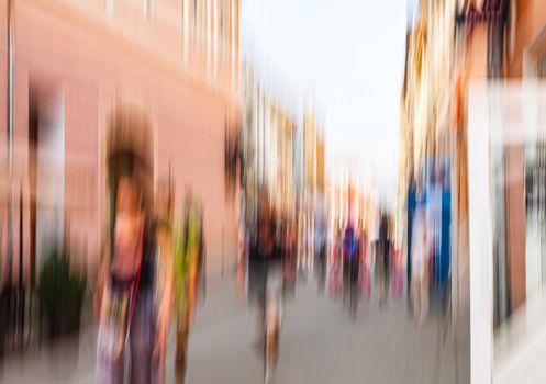 Urban city life background. Motion blur image of crowd of people walking on busy city street