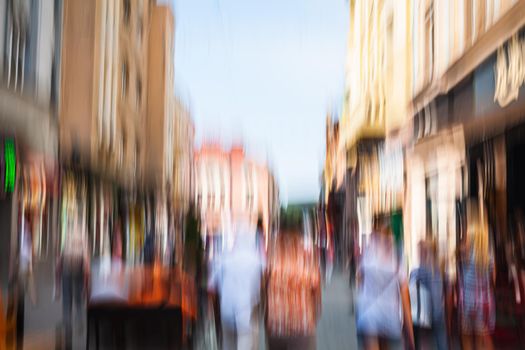 Urban city life background. Motion blur image of crowd of people walking on busy city street