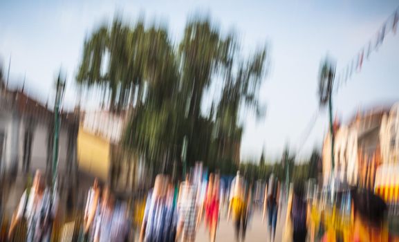 Urban city life background. Motion blur image of crowd of people walking on busy city street