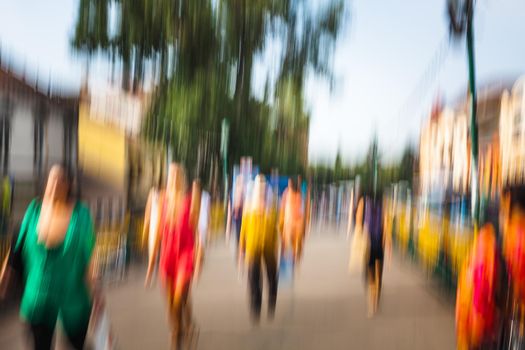 Urban city life background. Motion blur image of crowd of people walking on busy city street
