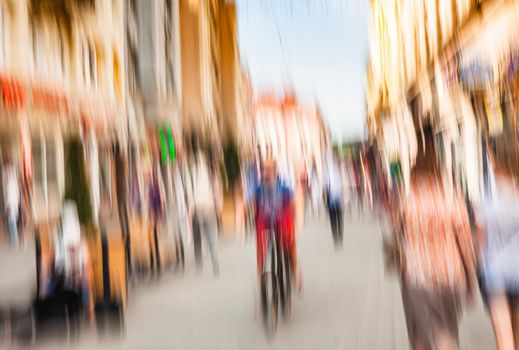 Urban city life background. Motion blur image of crowd of people walking on busy city street