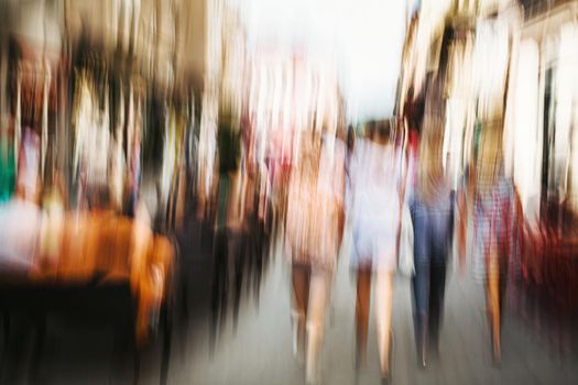 Urban city life background. Motion blur image of crowd of people walking on busy city street
