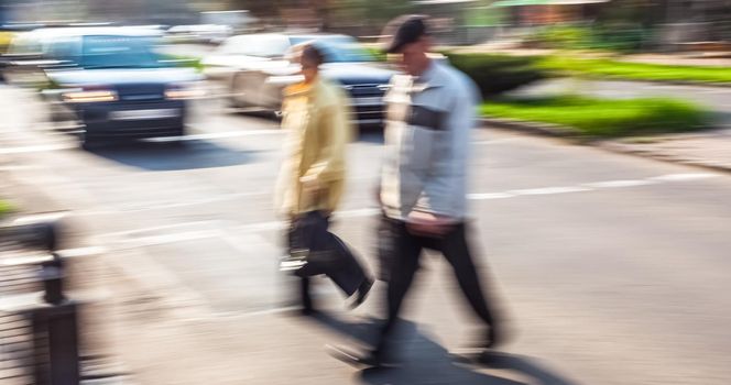 City life concept. People rushing in city. Abstract street scene in motion blur. Group of people at a pedestrian crossing