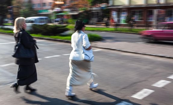 City life concept. People rushing in city. Abstract street scene in motion blur. Group of people at a pedestrian crossing