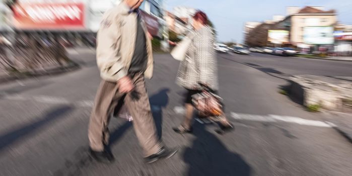 City life concept. People rushing in city. Abstract street scene in motion blur. Group of people at a pedestrian crossing