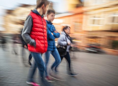 Abstract image of a young people group hurrying about their business. Intentional motion blur