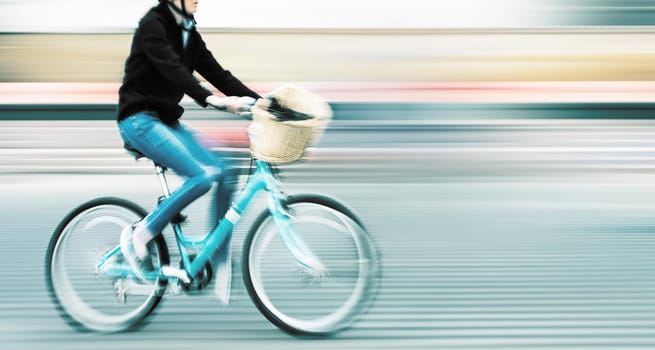 Abstract image of cyclist on the city roadway. Intentional motion blur and color shift
