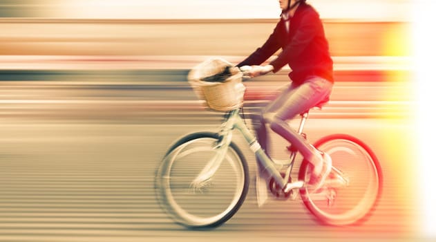 Abstract image of cyclist on the city roadway. Intentional motion blur and color shift