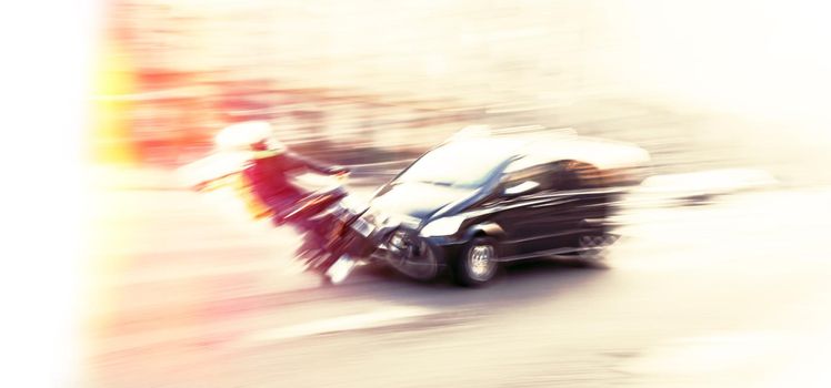 Dangerous city traffic situation with motorcyclist and car in the city in motion blur