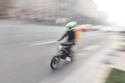 city traffic with a motorbike in motion blur