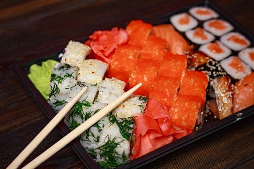 asian food sushi and roll set wooden sticks seafood. High quality photo