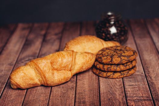 miscellaneous cookies sweets a cup of tea on a wooden table eating. High quality photo
