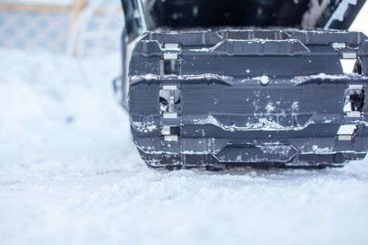 The back of a snowmobile in winter and riding in the snow on a snowmobile.