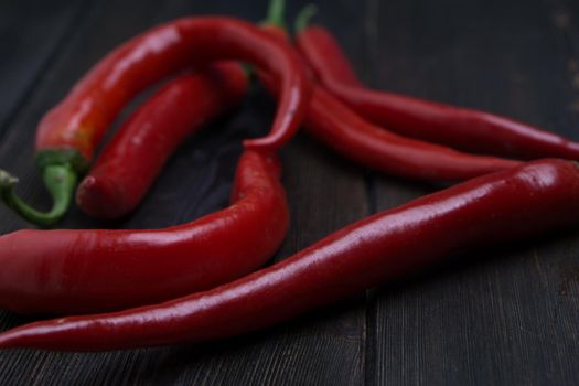 hot chili peppers red wooden table cooking food ingredients. High quality photo