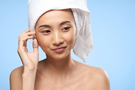 woman with bare shoulders close-up towel on head clean skin rejuvenation. High quality photo