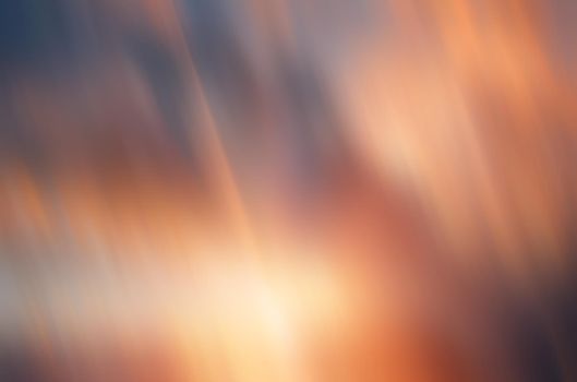 Blurred sunset cloudy sky background with sunrays