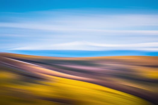 Abstract blurred mountains and blue sky background