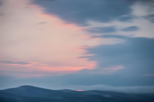 Abstract natural background.  Early morning light at mountain. Blurred sunrise background