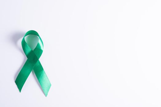 World kidney day, green ribbon awareness of kidney disease isolated white background.