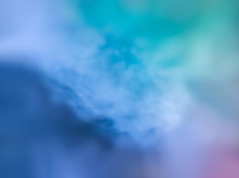 Defocused blurred abstract image of colorful smoke. Texture and abstract art