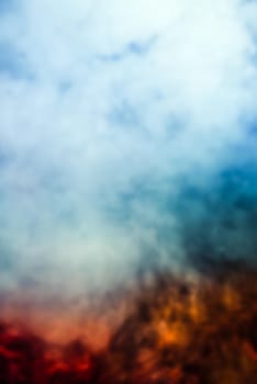 Soft focus abstract image of colorful smoke on dark background. Texture and abstract art