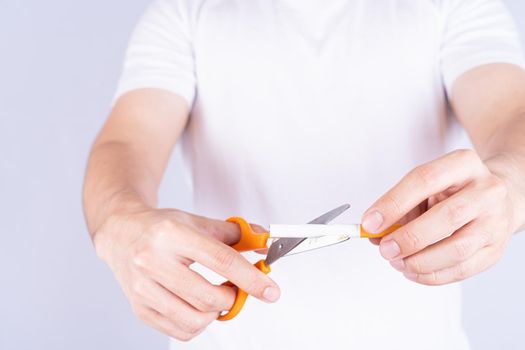 Male hand using scissors cutting cigarette. World no Tobacco and stop smoking day.