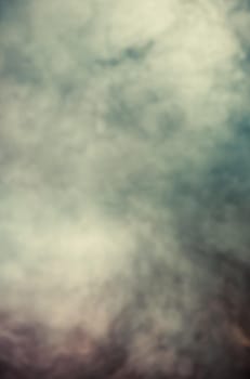 Soft focus abstract image of colorful smoke on dark background. Texture and abstract art