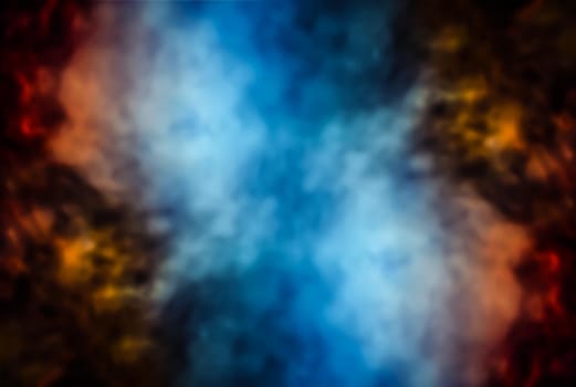 Soft focus abstract image of colorful smoke on dark background. Texture and abstract art