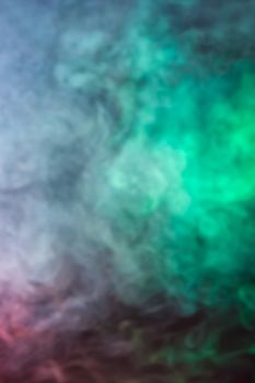 Soft focus abstract image of colorful smoke on dark background. Texture and abstract art