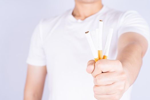 Male hand crushing cigarette. World no Tobacco and stop smoking day.