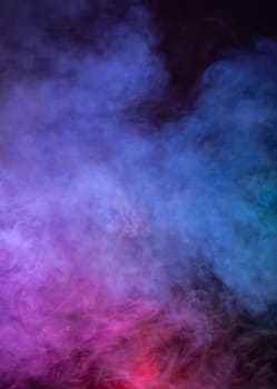 Soft focus abstract image of colorful smoke on dark background. Texture and abstract art