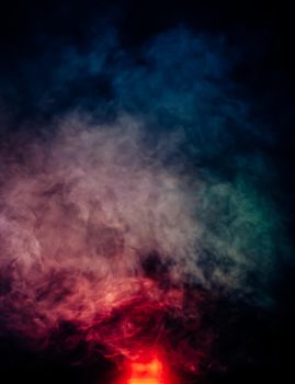 Soft focus abstract image of colorful smoke on dark background. Texture and abstract art