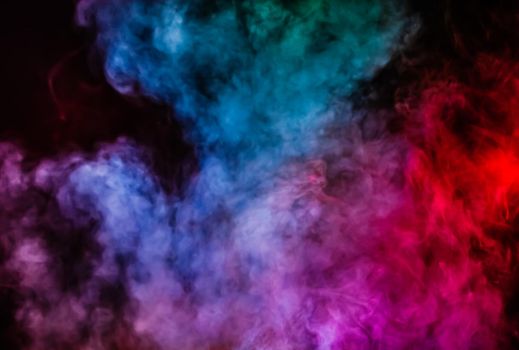 Soft focus abstract image of colorful smoke on dark background. Texture and abstract art