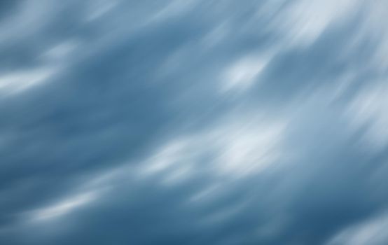 Defocused natural sky background with motion blur. Nature background