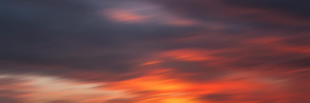 Blurred nature background. Smooth relax landscape. Abstract sunset sky with motion blurred clouds