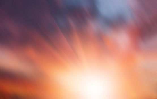 Blurred sunset cloudy sky background with sunrays  