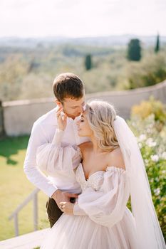 Wedding couple in the garden at sunset. Wedding in Florence, Italy, in an old villa-winery.