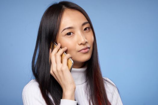 woman of asian appearance talking on the phone technology internet. High quality photo