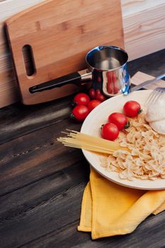 italian pasta cherry tomatoes cooking food kitchen wooden table. High quality photo