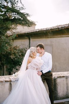 Wedding couple on the roof of an old winery villa. Wedding at an old winery villa in Tuscany, Italy.