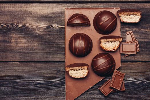 bar chocolate marshmallow sweets delicacy wooden table. High quality photo