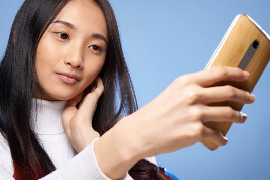 pretty brunette with a phone in her hands the charm of internet communication technology close-up. High quality photo