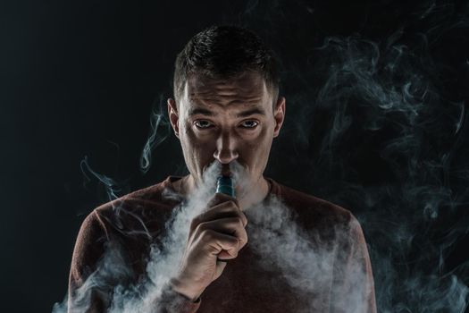 man smokes vape smoke Electronics vaping nicotine. High quality photo