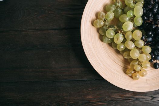 multicolored grapes on a plate vitamins fruit freshness organic. High quality photo