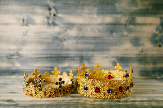 Two golden crowns encrusted with precious stones for a religious wedding in an Orthodox church