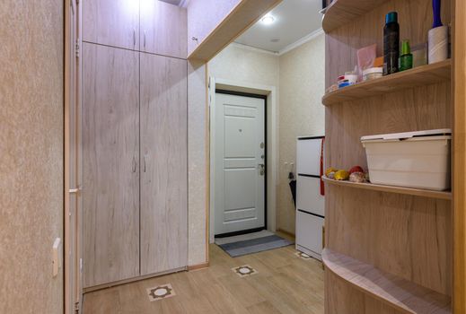 Interior of a classic hallway room with a large wardrobe in a studio apartment