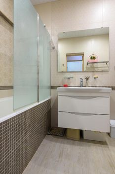 Glass shower partition in the bathroom interior