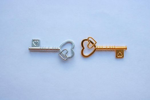 Gold and silver keys, with hearts isolated on a white background.