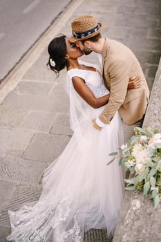 Interracial wedding couple. Wedding in Florence, Italy. African-American brid in white dress and Caucasian groom.