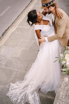 Interracial wedding couple. Wedding in Florence, Italy. African-American brid in white dress and Caucasian groom.